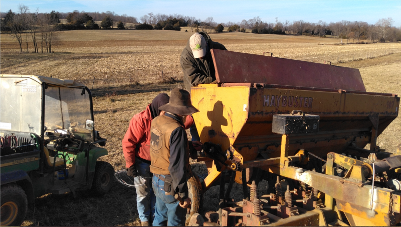 Image of Virginia Cooperative Extension agents John Benner, Frank Nolen, and Will Nolen working on a no-till drill back.