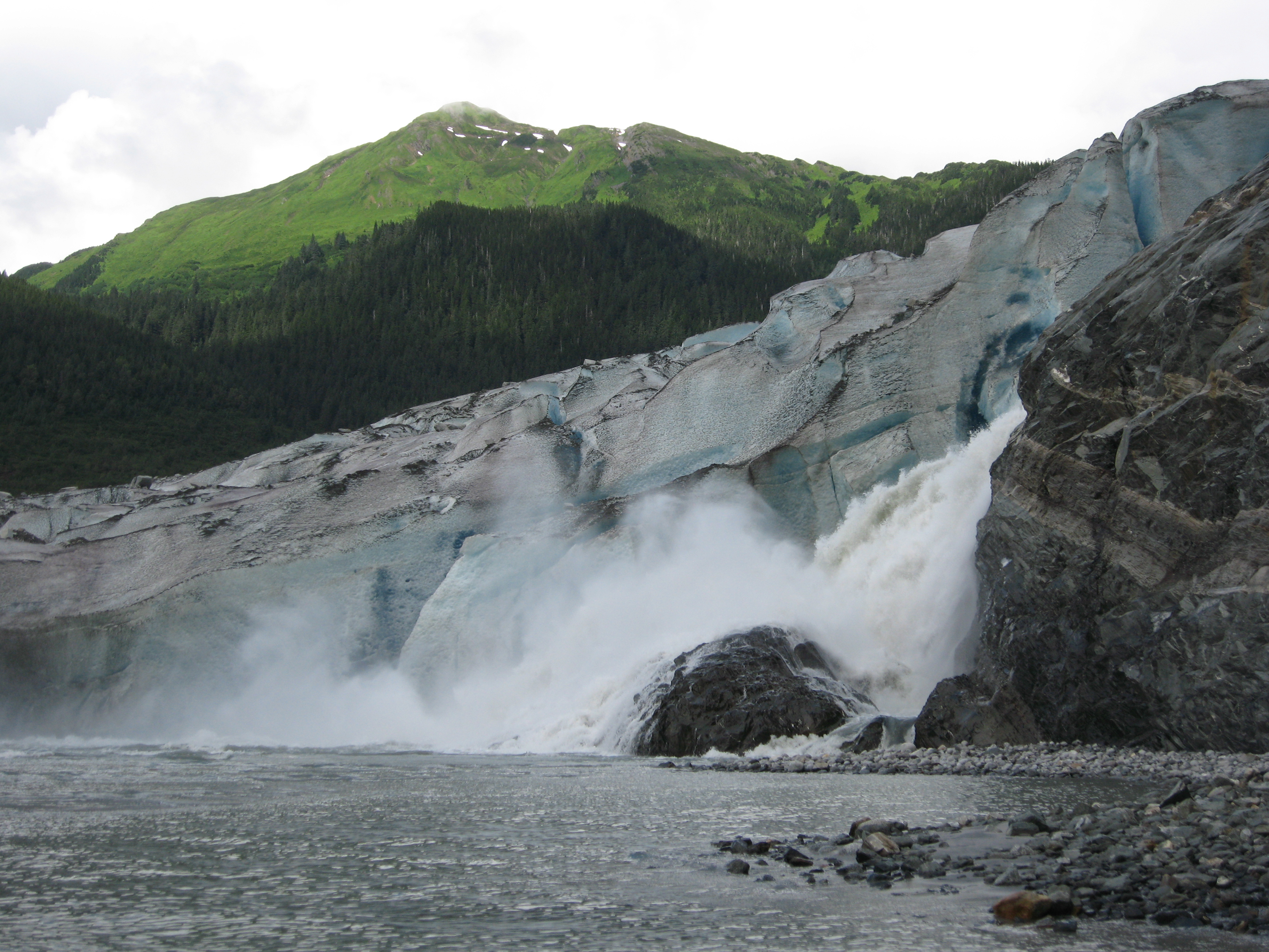 A melting glacier in front of a mountain.