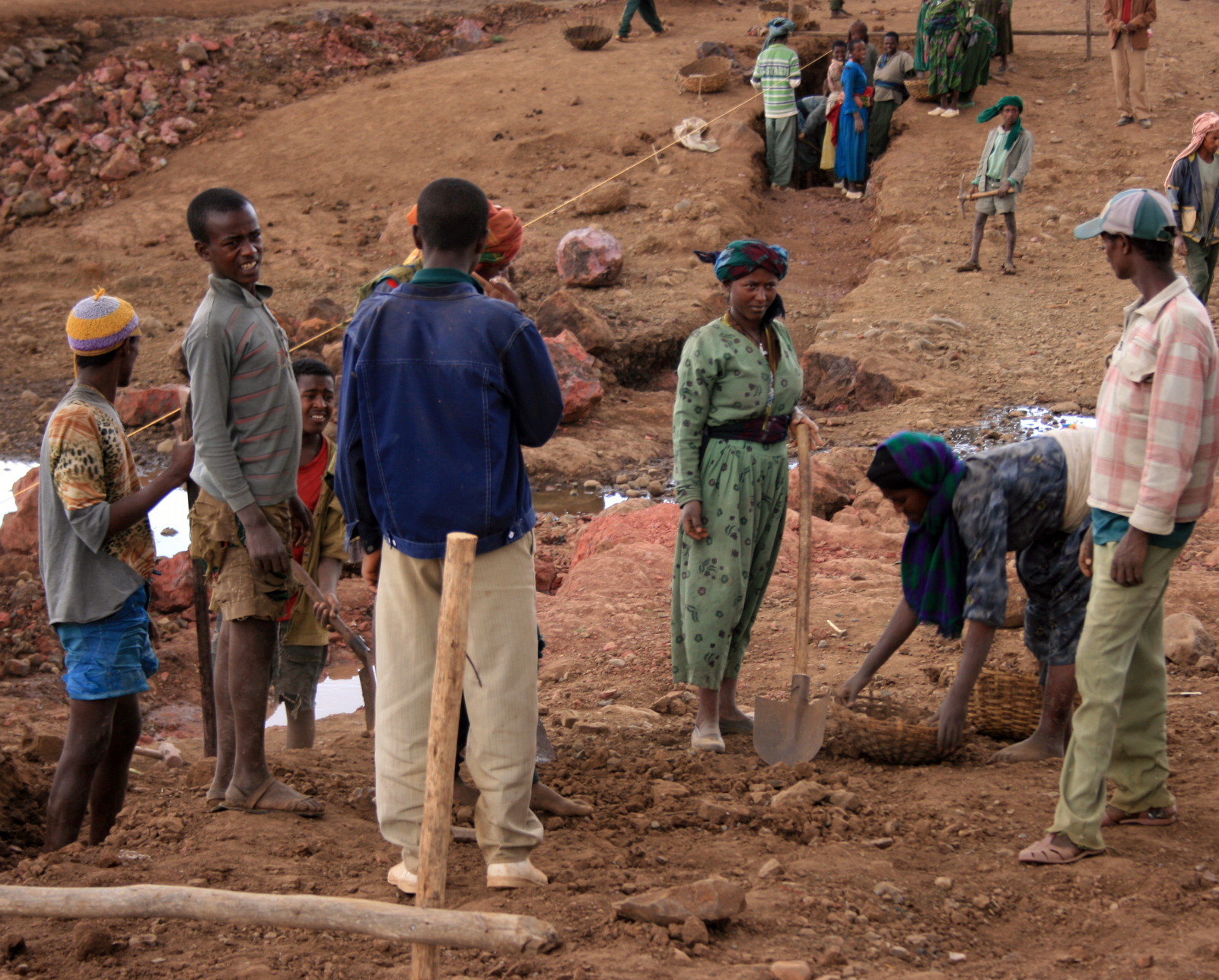 A group of Ethiopians work build a stream crossing.