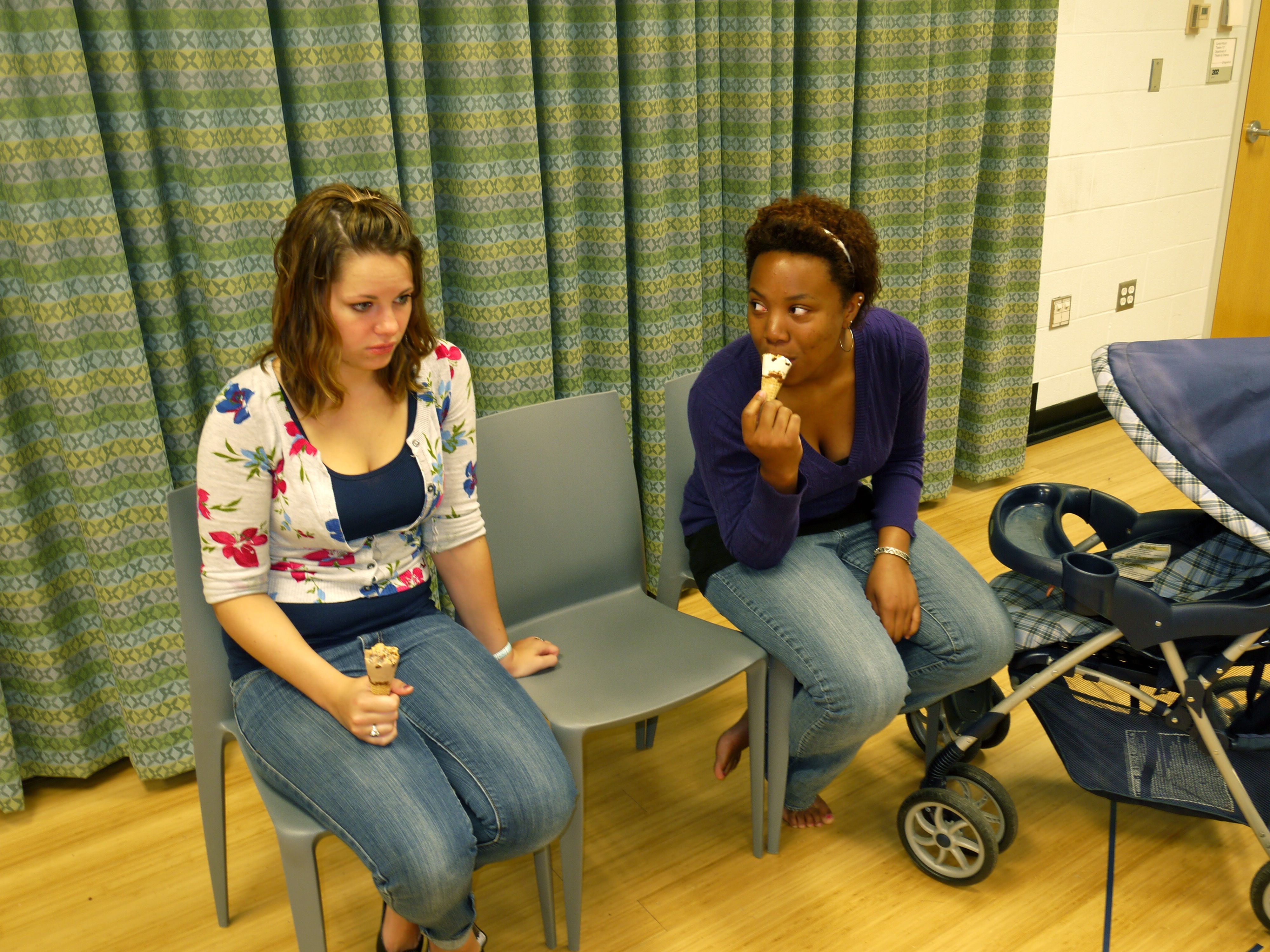 Alexis Demetra Baker (right) and Kristian Yelverton sit in chairs with ice cream cones.