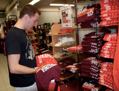 A student studies the 2011 Orange and Maroon Effect shirts.