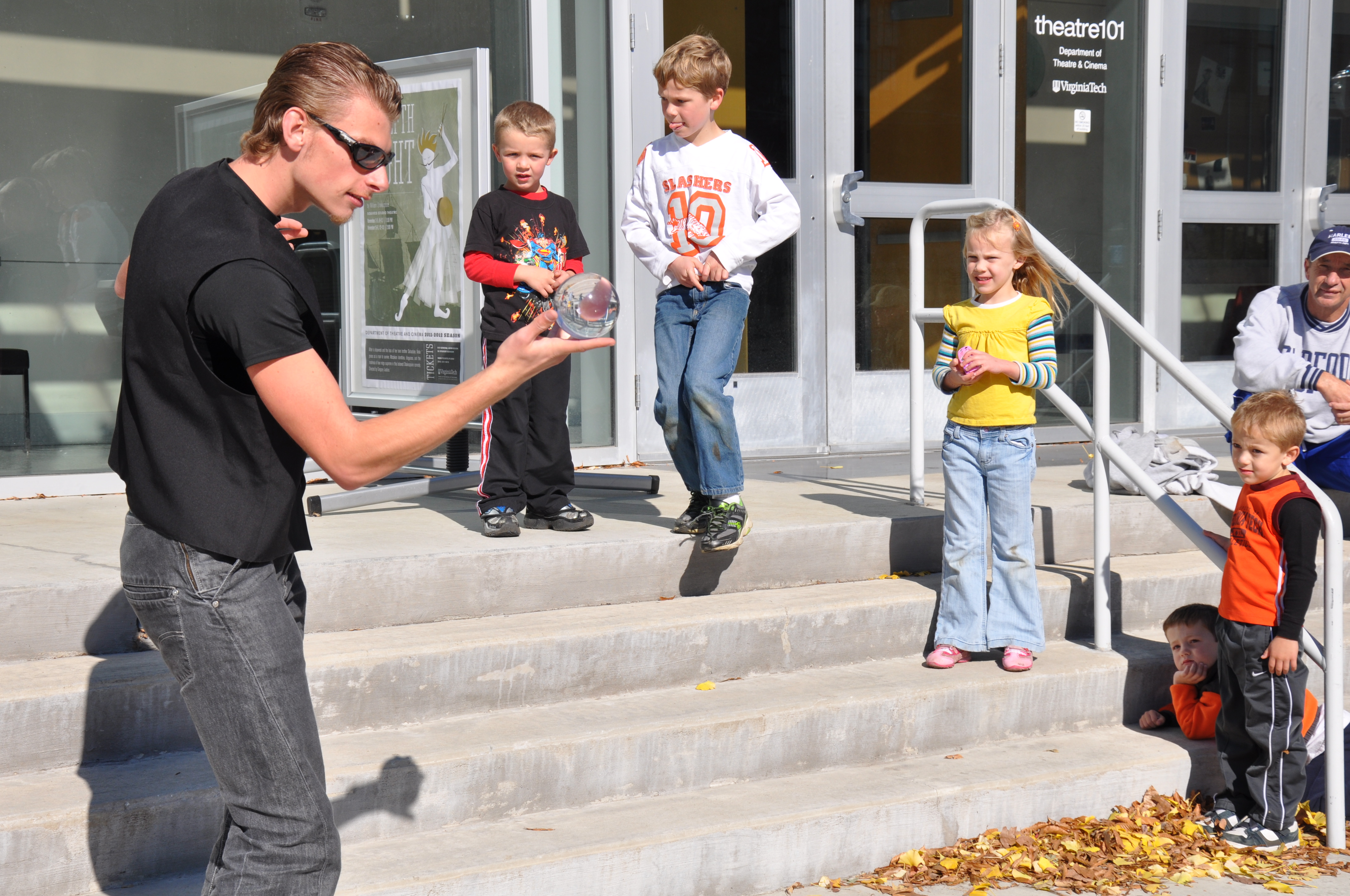 Youngsters watch with anticipation as a Virginia Tech student entertains them with illusions.