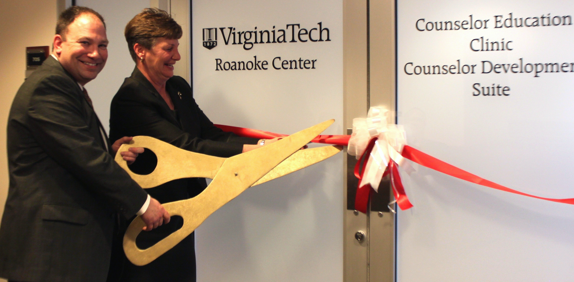 Gerard Lawson and Susan Short of Virginia Tech cut ribbon.