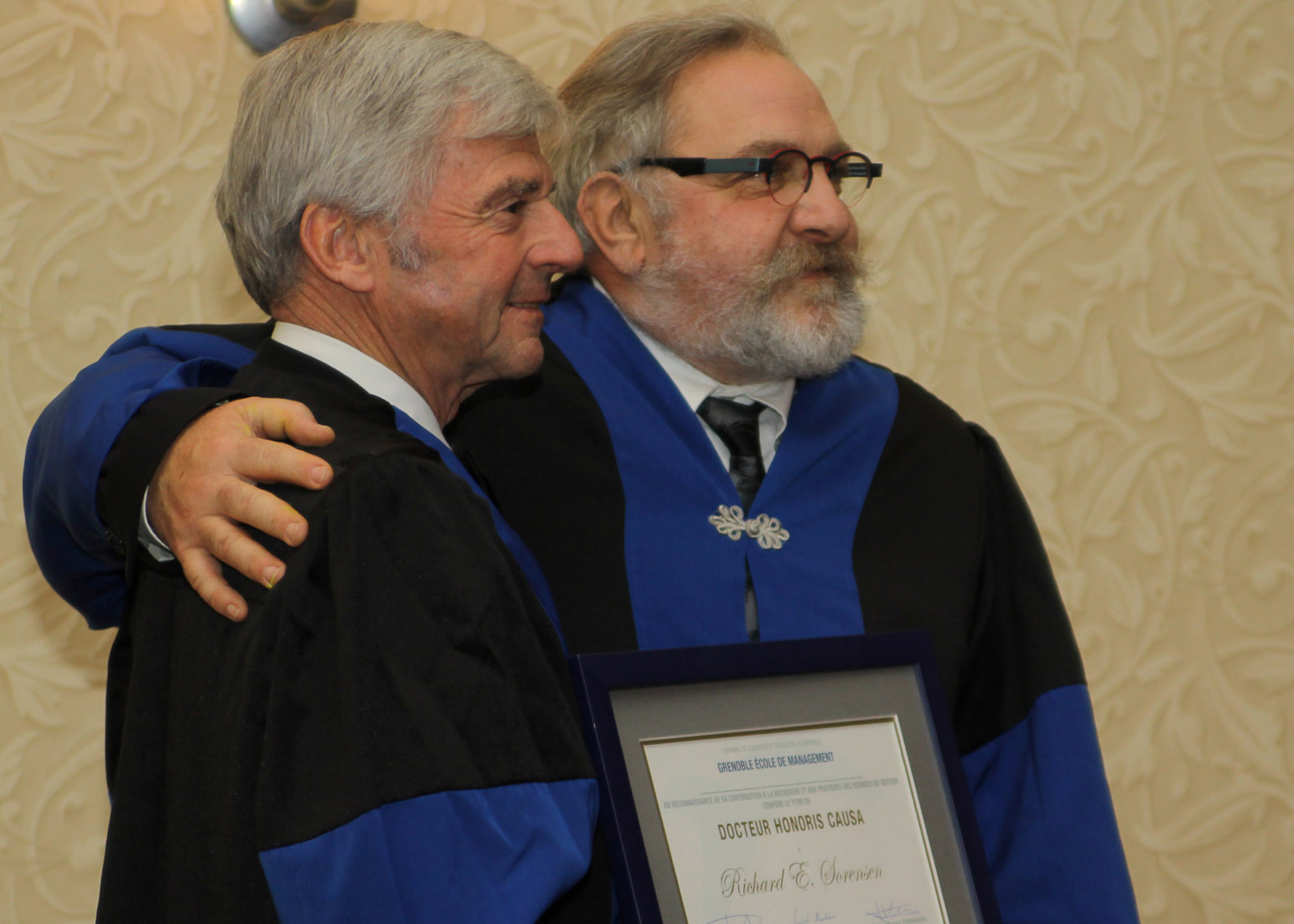 Pamplin Dean Richard E. Sorensen (left) and Thierry Grange of the Grenoble Ecole de Management pose with the honorary doctorate presented to Sorensen. 