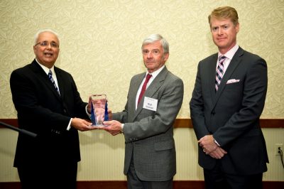 Retiring Pamplin College dean Richard E. Sorensen is presented the Distinguished Leadership Award of AACSB International by its president and CEO John Fernandes (left). On the far right is AACSB vice president of outreach, Michael Wiemer.