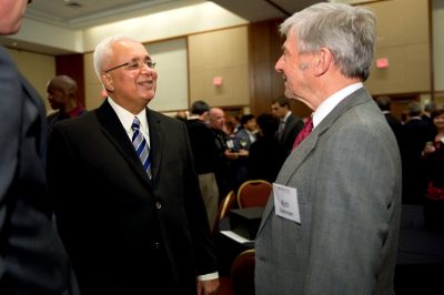 AACSB International president and CEO John Fernandes (left) chats with Pamplin College dean Richard E. Sorensen at the dean's retirement reception.