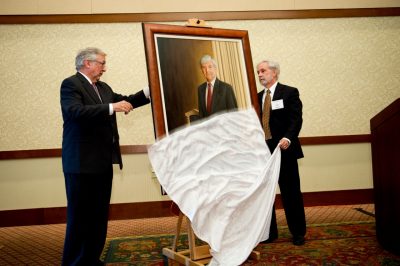 The portrait of retiring Pamplin College dean Richard E. Sorensen is officially unveiled by president Charles Steger (left) and finance professor and department head Art Keown.