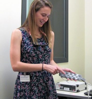 Stephanie Wiltman demonstrates the fNIRS device.