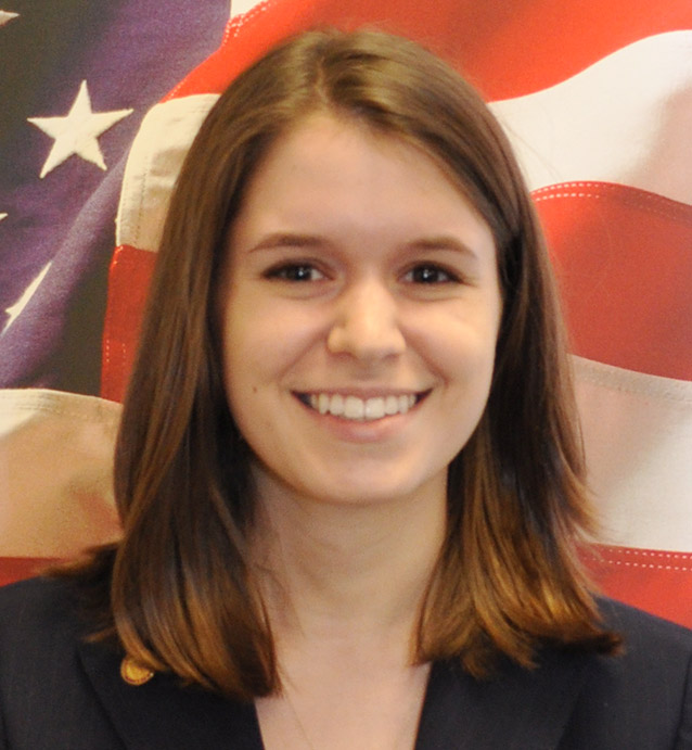 Female student headshot in front of American flag
