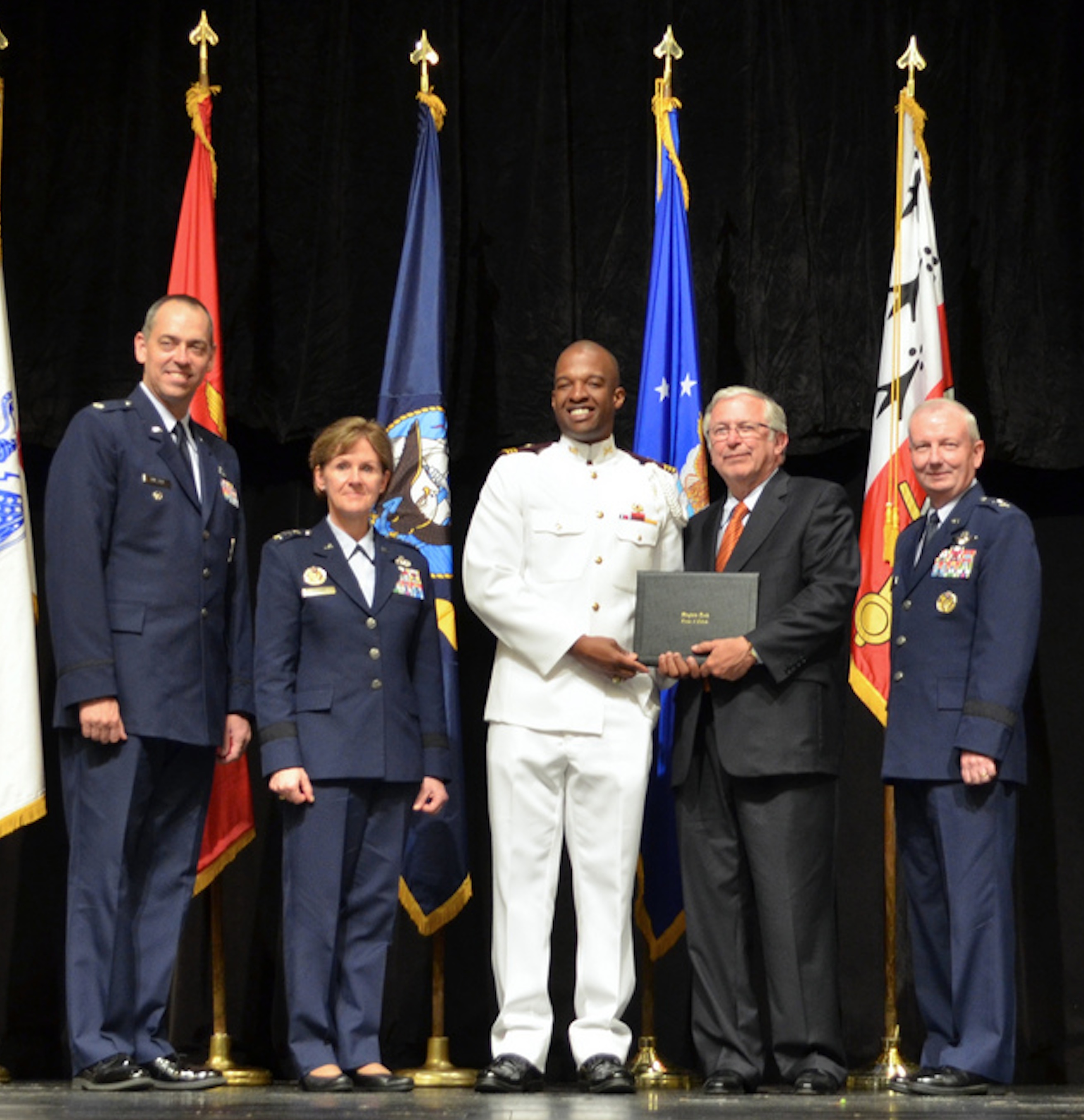President Charles W. Steger awards a graduation certificate from the Corps of Cadets to Kareim Oliphant last May in the Burruss Hall auditorium.