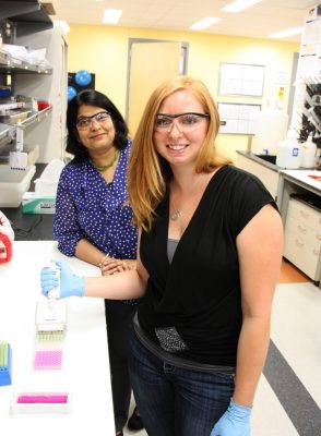 Rebekah Less, right, and Padma Rajagopalan stand in the lab