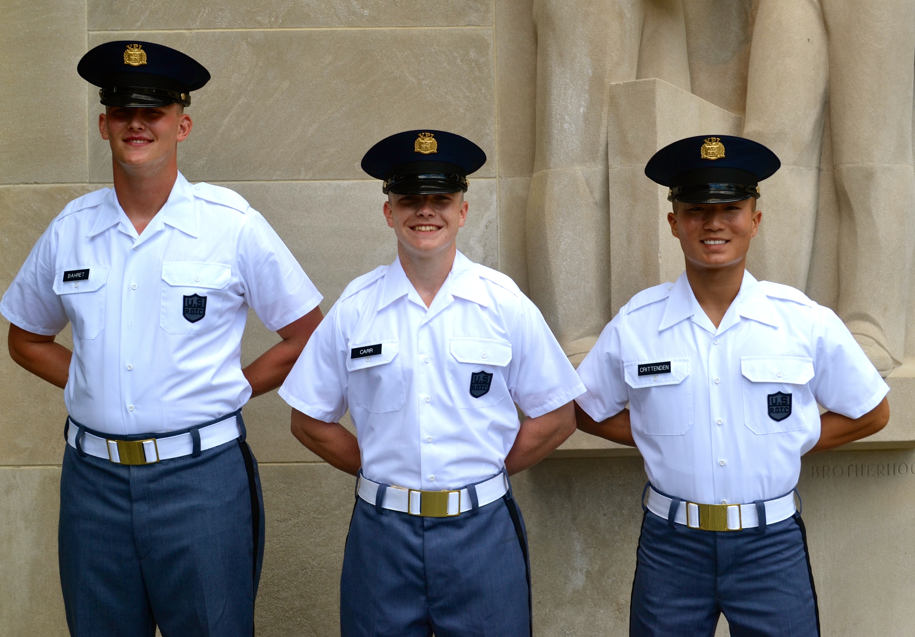 From left to right are Cadets Joseph Bahret, Christian Carr, and Sean Crittenden standing in front of the Pylons.