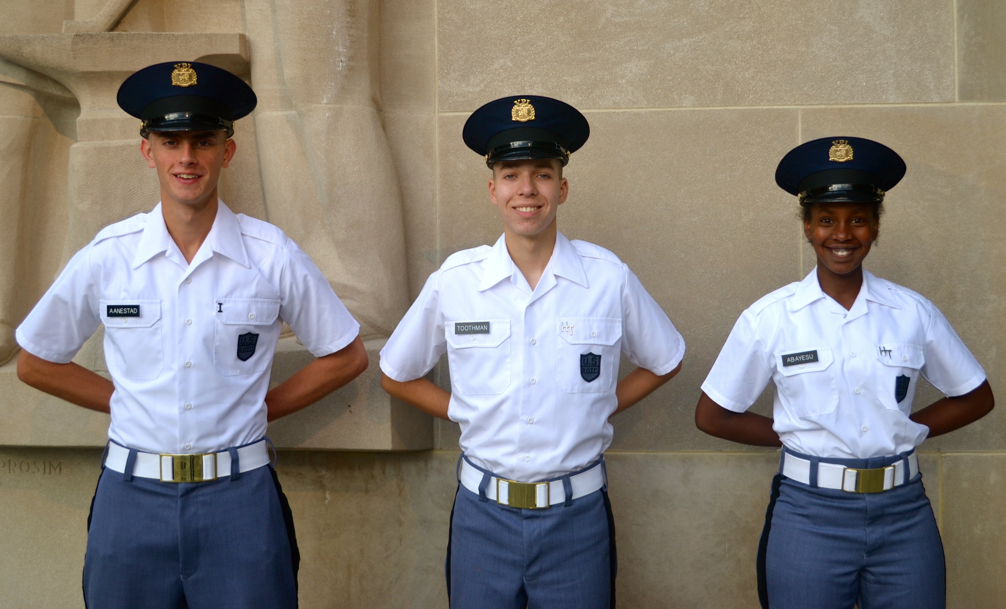 From left to right are Cadets Paul Aanestad, Zachary Toothman, and Precious Abayesu standing in front of the Pylons.