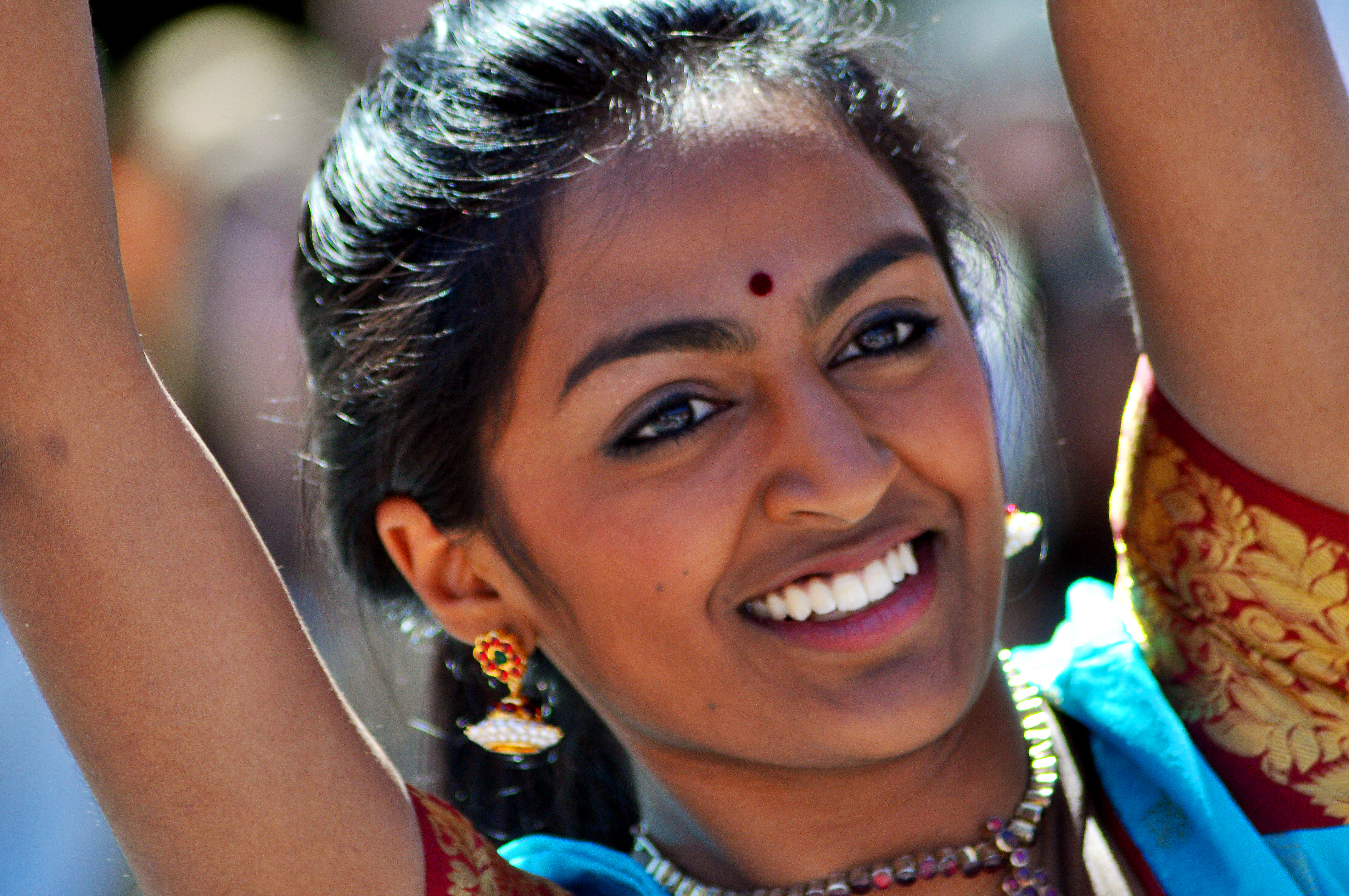 A dancer smiles as she performs at the International Street Fair.