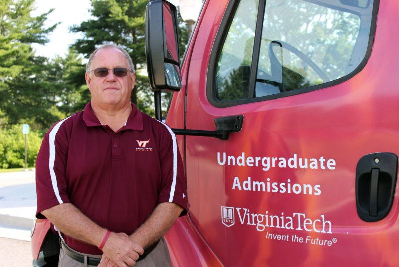 Wilson stands in front of the Office of Undergraduate Admission’s tour bus.