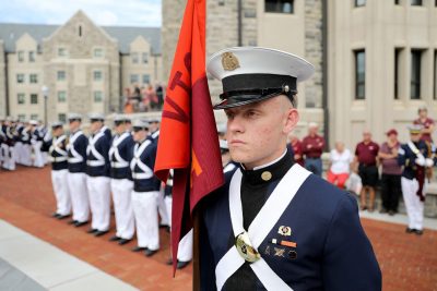 Cadet Colin McNees carries the guidon for the corps’ Alpha Company.