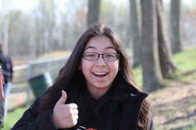 Genevieve Gural gives a thumbs-up while at Baja SAE's most recent competition in April 2018 in Maryland. Photo by John Stout.