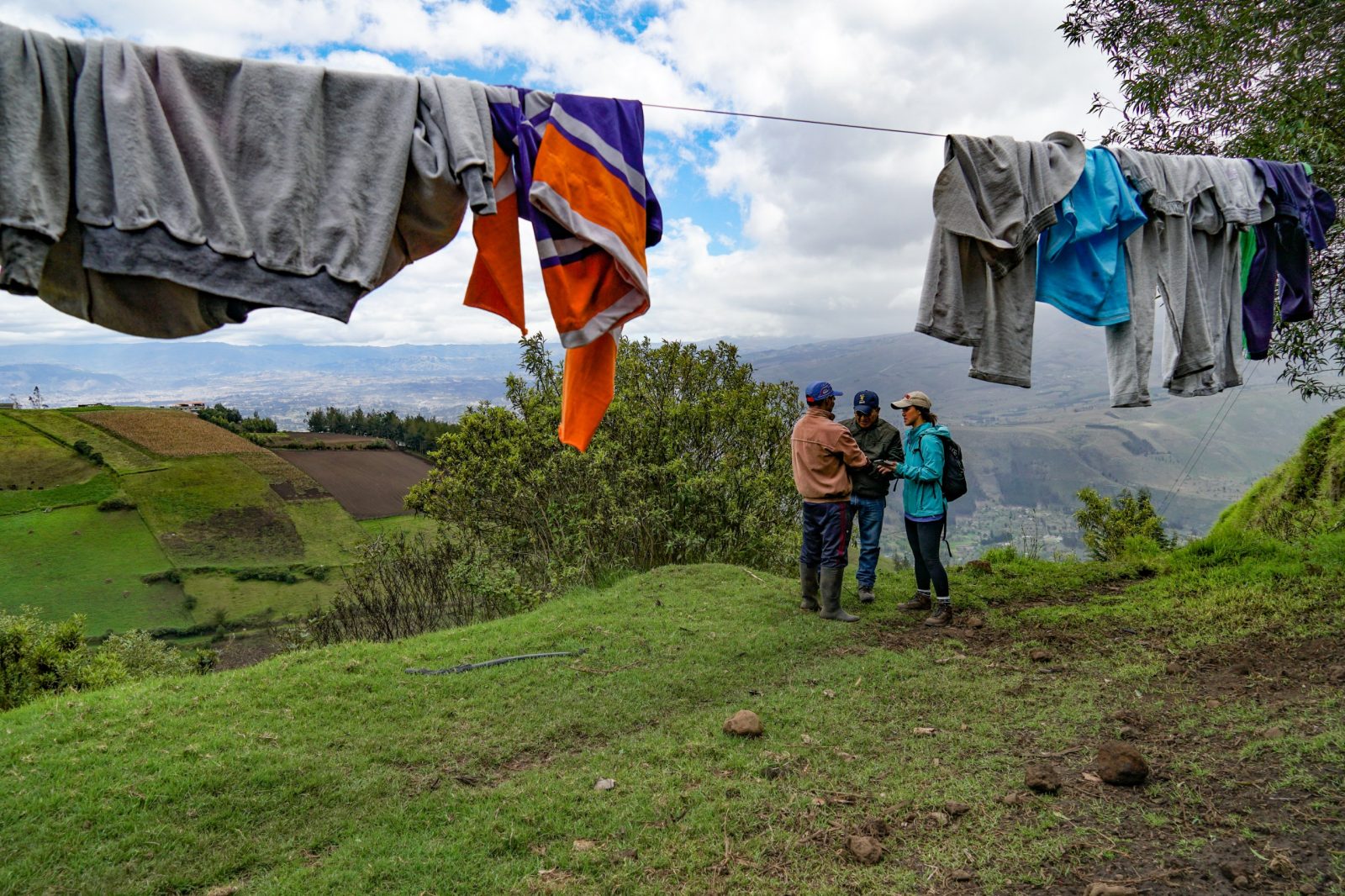 Rachel Thornton surveys Ecuadorian farmer with INIAP partner.