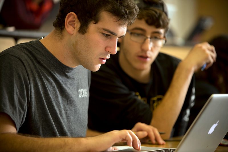 Two Virginia Tech students gaze at a laptop