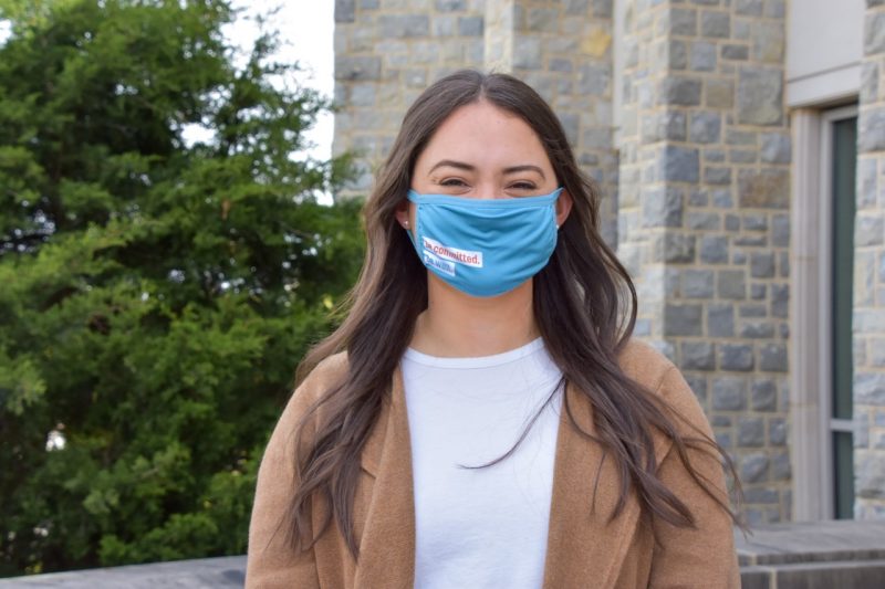 Christine Faunce is the Virginia Tech College of Science's Outstanding Senior for 2021. Here she stands outside the Life Sciences Building 1, wearing a mask, where she has carried out benchwork research. Photo by Melissa Vergara.