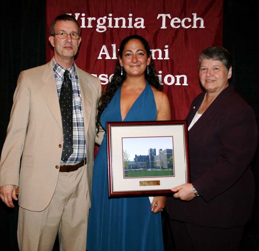 Lara A. Pappas (center), received the College of Agriculture and Life Sciences' Recent Alumna Award from Michael Denbow, professor of animal and poultry sciences (left) and Sharron Quisenberry, dean of the College of Agriculture and Life Sciences.