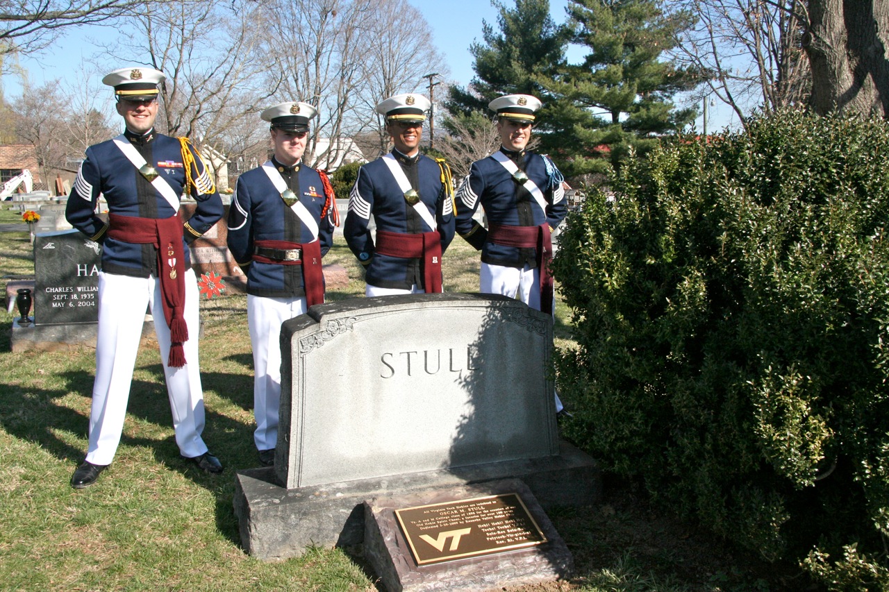 Cadets stand with the memorial stone and plaque.