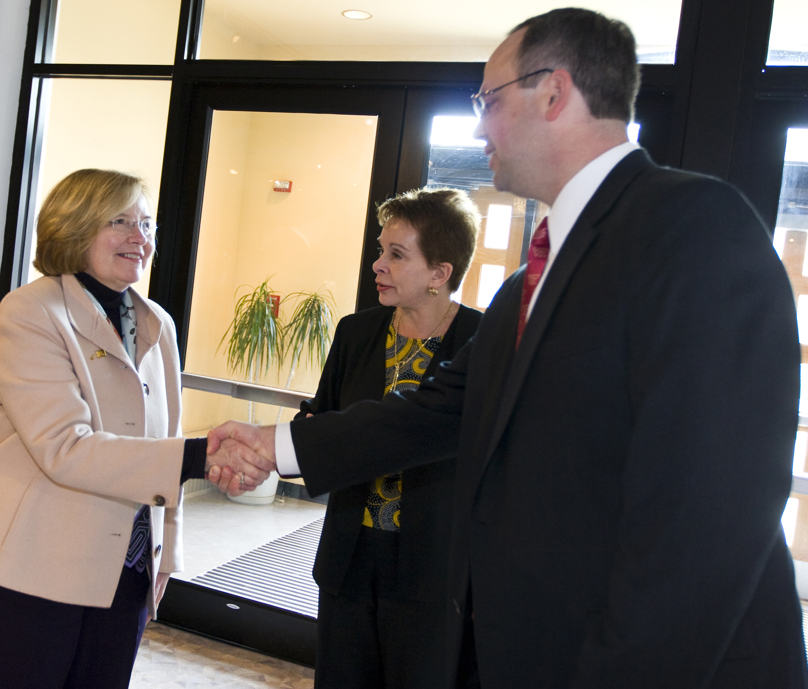 Linda Marshall (left) a partner and director of IBM's Department of Defense Systems Integration Executive Global Services, shakes hands with Stefan Duma, professor of mechanical engineering at Virginia Tech. Deborah Hamilton (middle) is the associate director, corporate and foundation relations, College of Engineering, Virginia Tech. IBM is a critical partner, along with Renesola, and Grundfos Pumps, on the Virginia Tech engineering project to provide electricity to a remote medical clinic in Kenya.