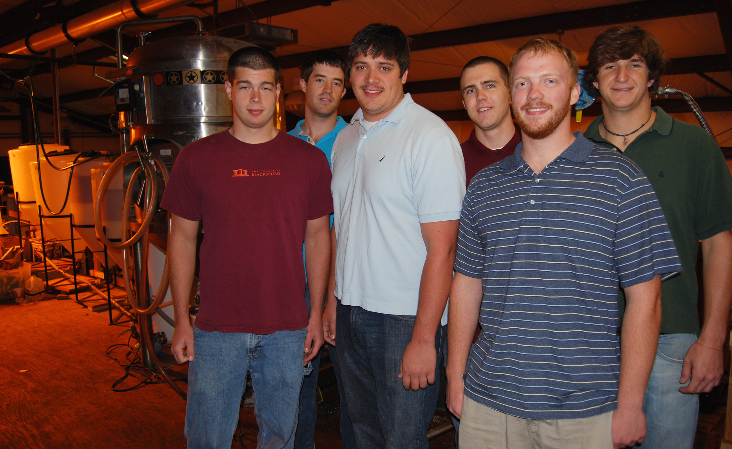 The Virginia Tech Bio-Fuels senior design team spent the better part of two years refining a biodiesel system that converts waste vegetable oil into an environmentally friendly product with high mpg. Left to right are Andrew Yard, Matteo del Ninno, Christopher Chelko, Brian Eggleston, Blake Gordon and Christopher Block. Not pictured is Meredith Herrmann. Behind the students are tanks, agitators, heaters and assorted equipment used to make the fuel.