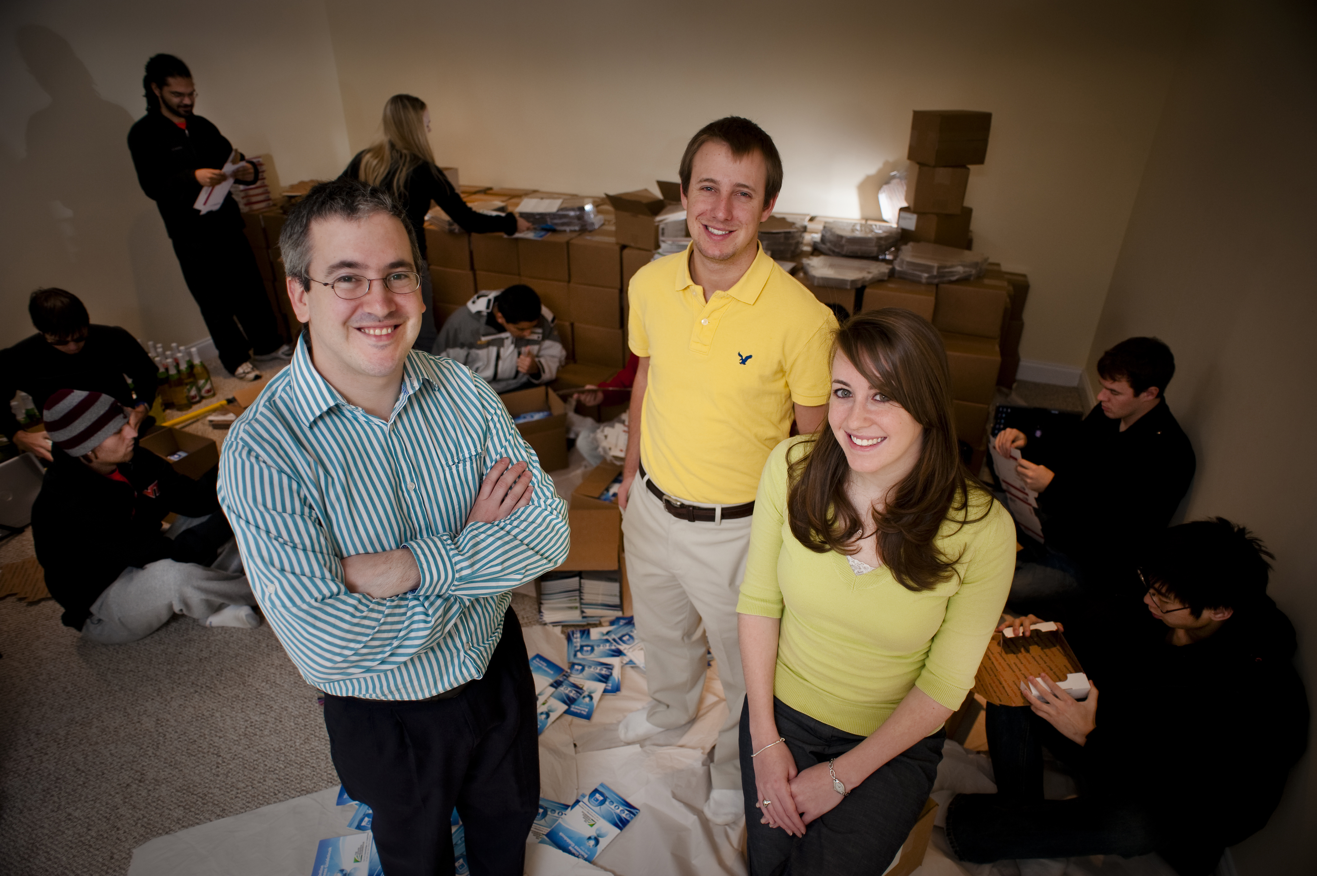 Coming to a small business development center near you: Professor Alan Abrahams (left); guidebook CEO Damon Silva, a senior in economics from Seaford, Va.; executive director Andrea Lovett, a senior in communication from Greensboro, N.C.; and other students pack their books to ship to 500 small business development centers around the country.