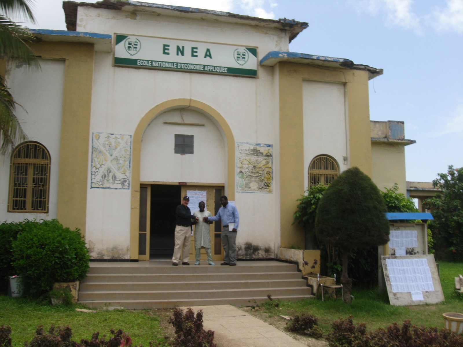 Virginia Tech officials confer with an official at a Senegalese partner university.