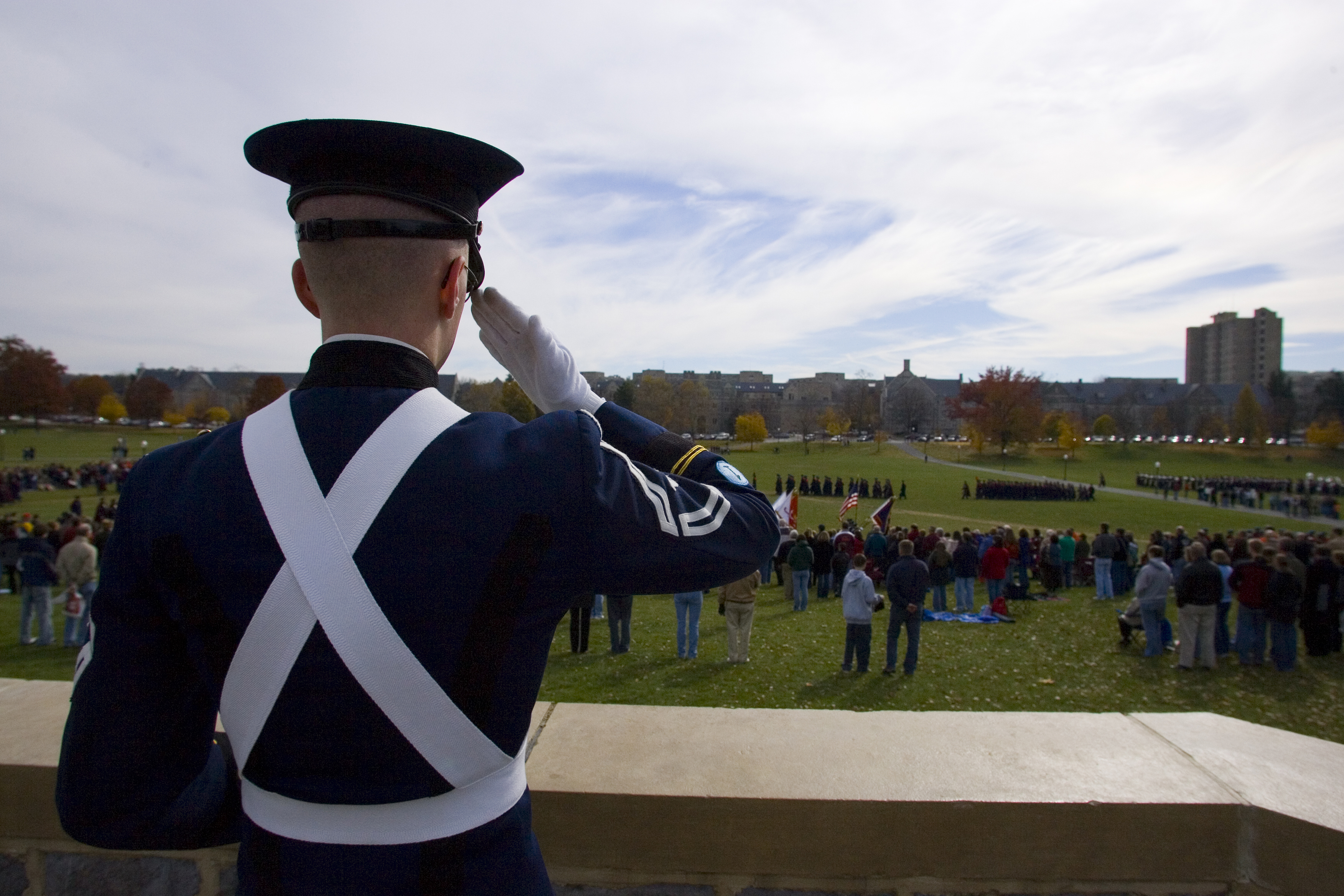 A cadet watches the corps perform the pass in review. 