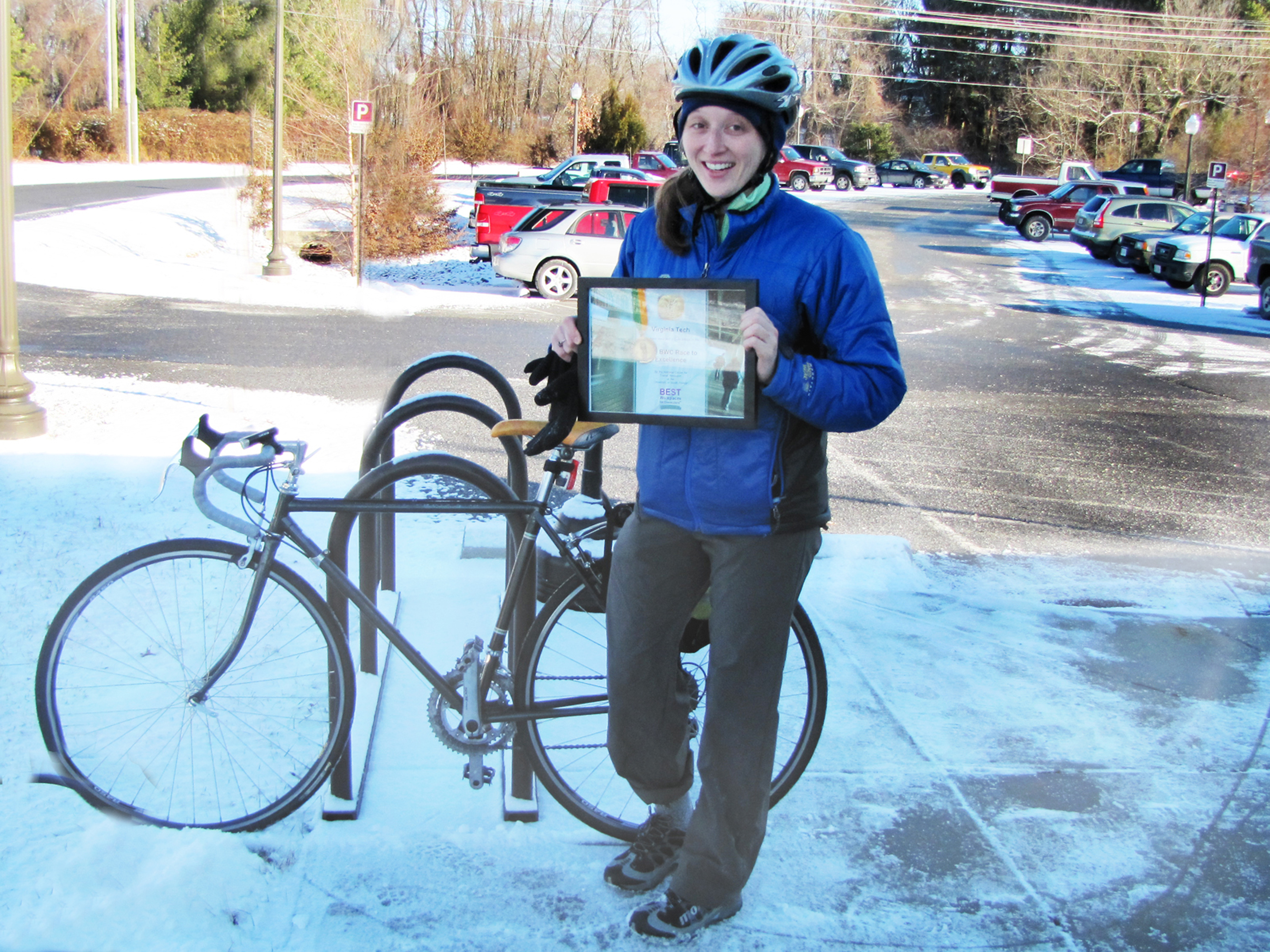 Amada Chassot holds the certificate in front of a bike.
