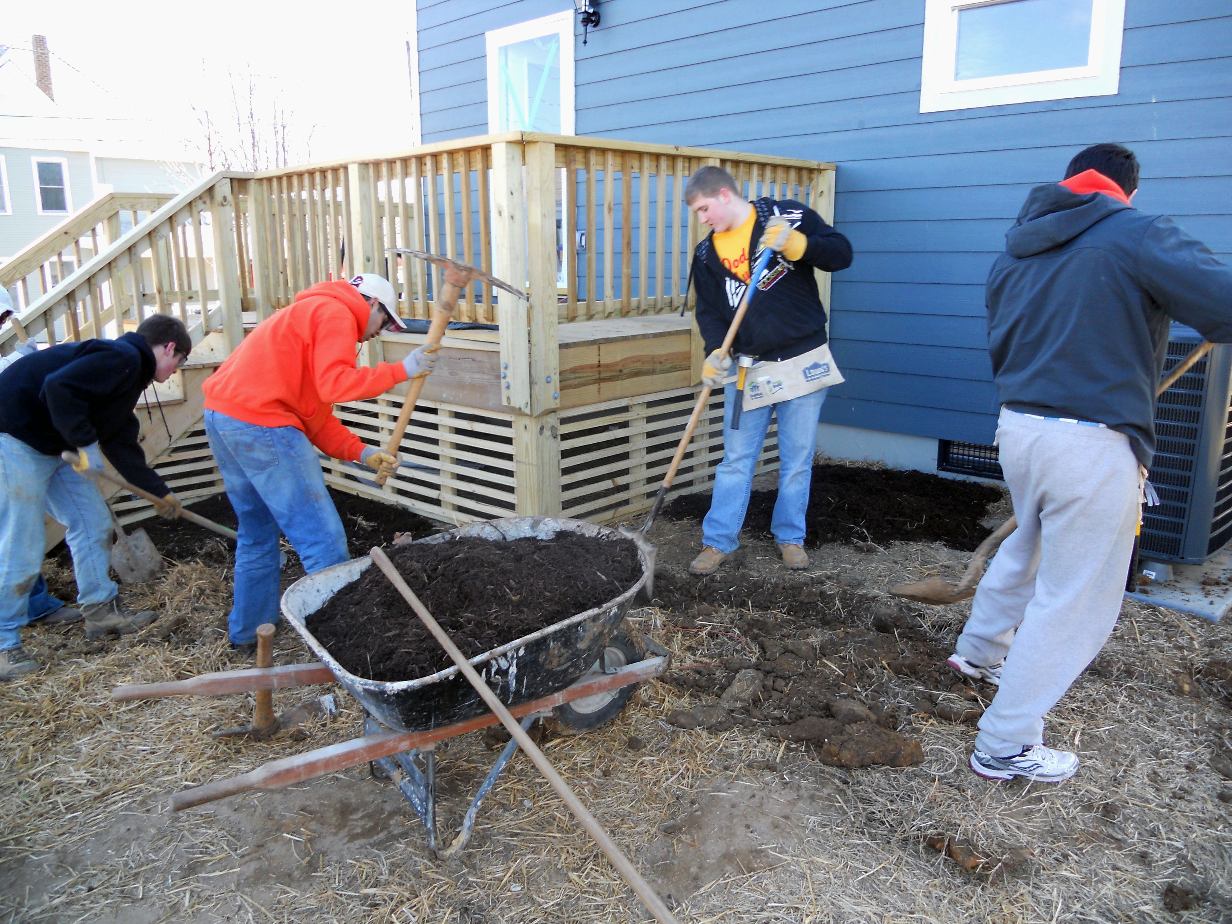 Students landscaping in the garden of a Habitat for Humanity house