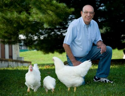 man with 3 chickens