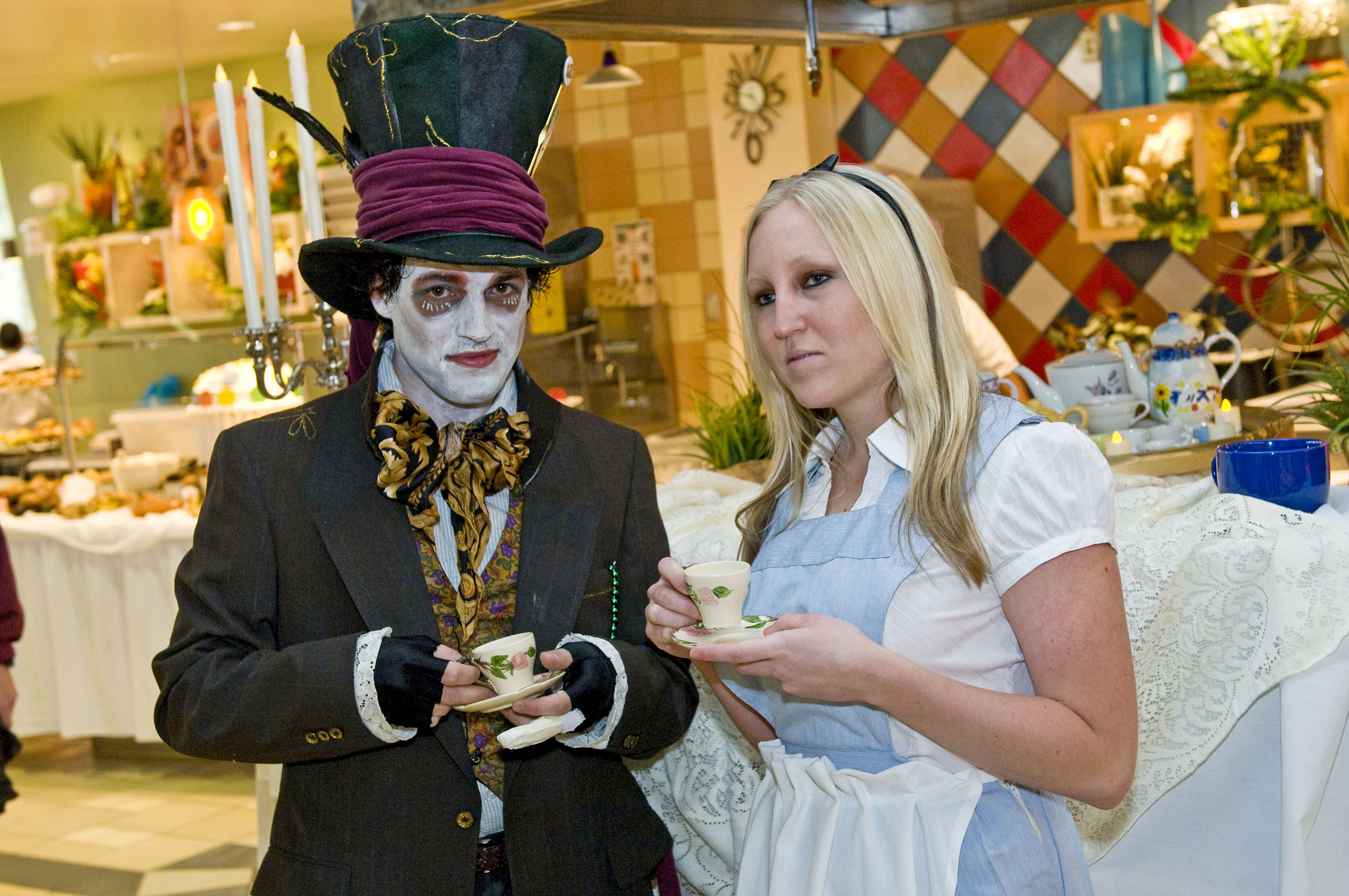 Dining Services employees dressed as Mad Hatter, left, and Alice characters.