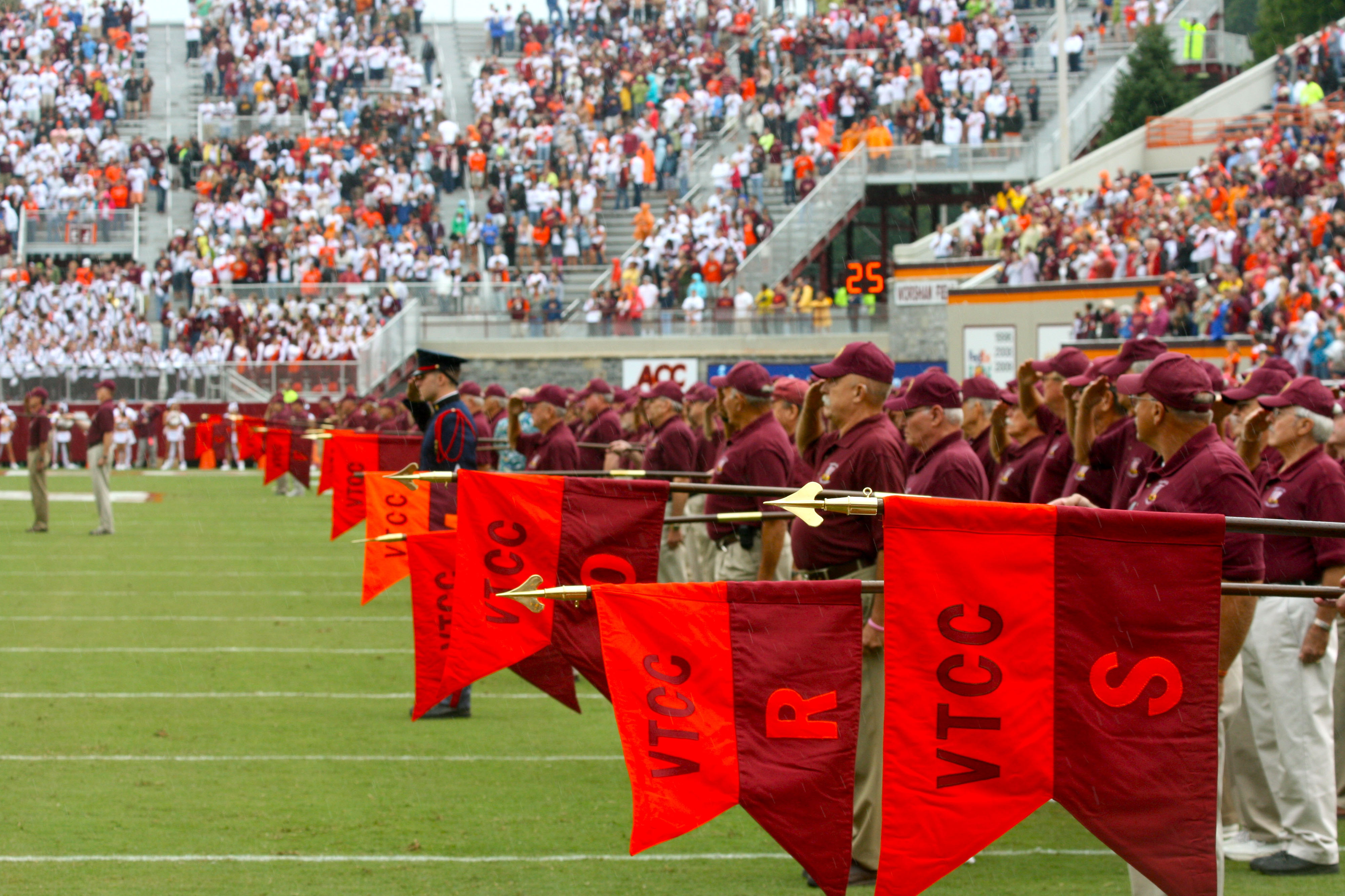 Alumni of the Virginia Tech Corps of Cadets join the Regiment on the field prior to the Corps Homecoming game in 2010