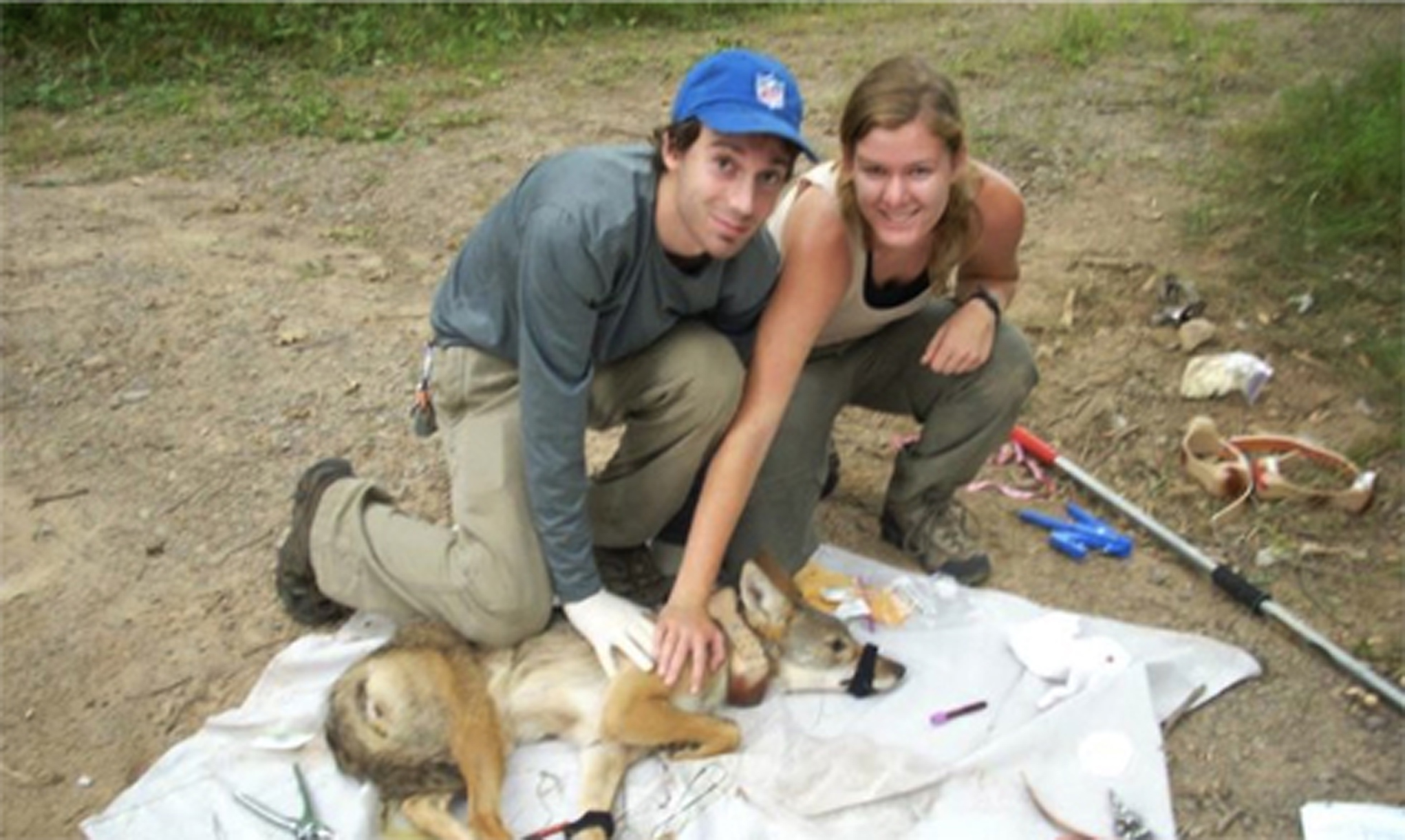 Students pose with a trapped coyote.