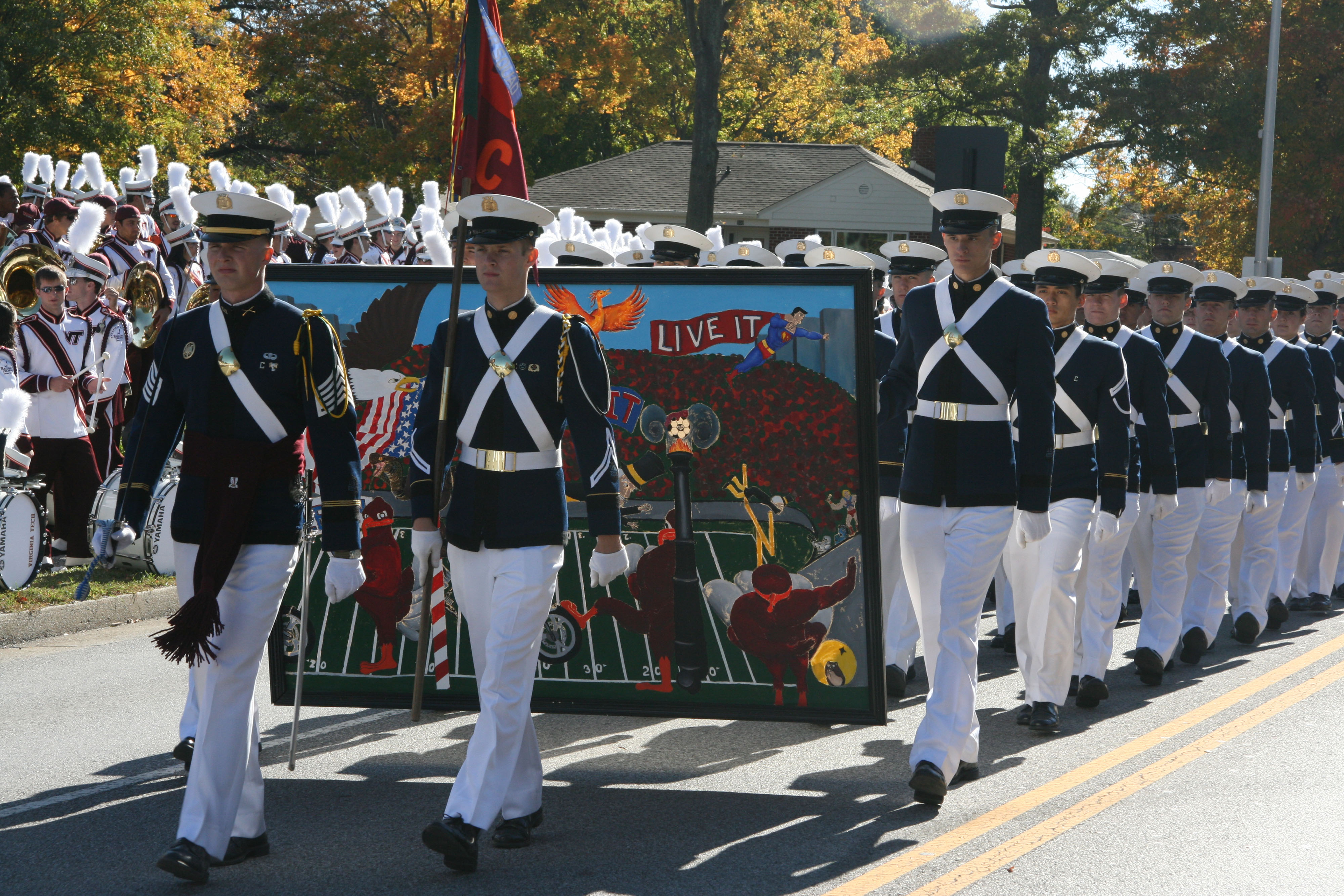 Members of the Virginia Tech Corps of Cadets march during the 2010 Homecoming Parade carrying their unit homecoming banner