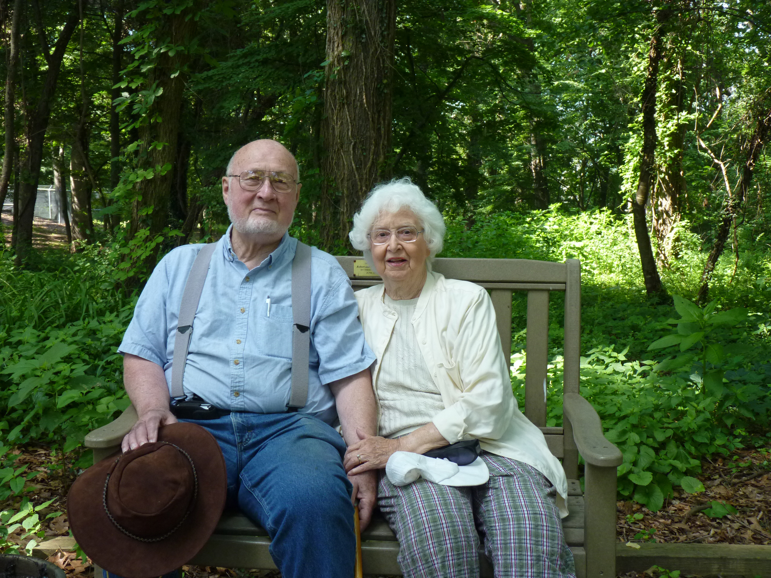 Bob and Esther Youngs sitting on a bench in the International Peace Garden