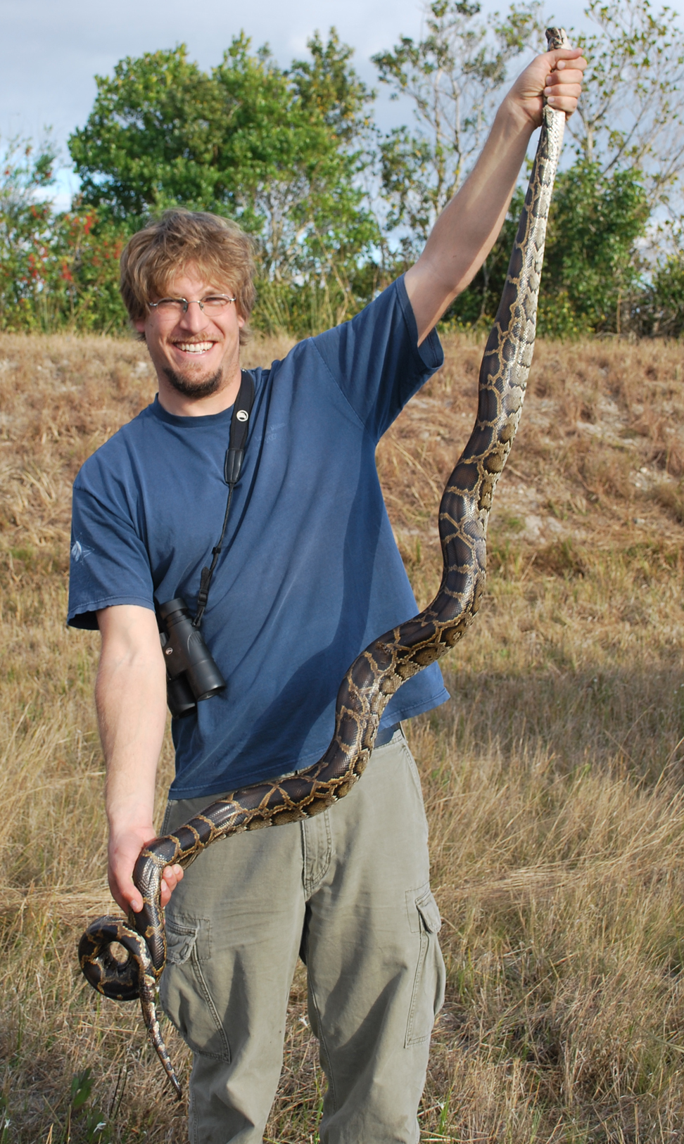 John Willson holding a Burmese python