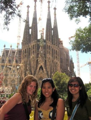 Three students in front of a cathedral
