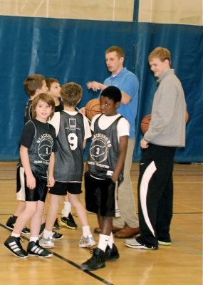 Taylor Kewer and Derek Baker coach fifth graders in Blacksburg Recreation league basketball.