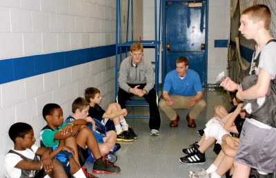 Derek Baker and Taylor Kewer conduct a post-game debriefing with Blacksburg Recreation league basketball players.