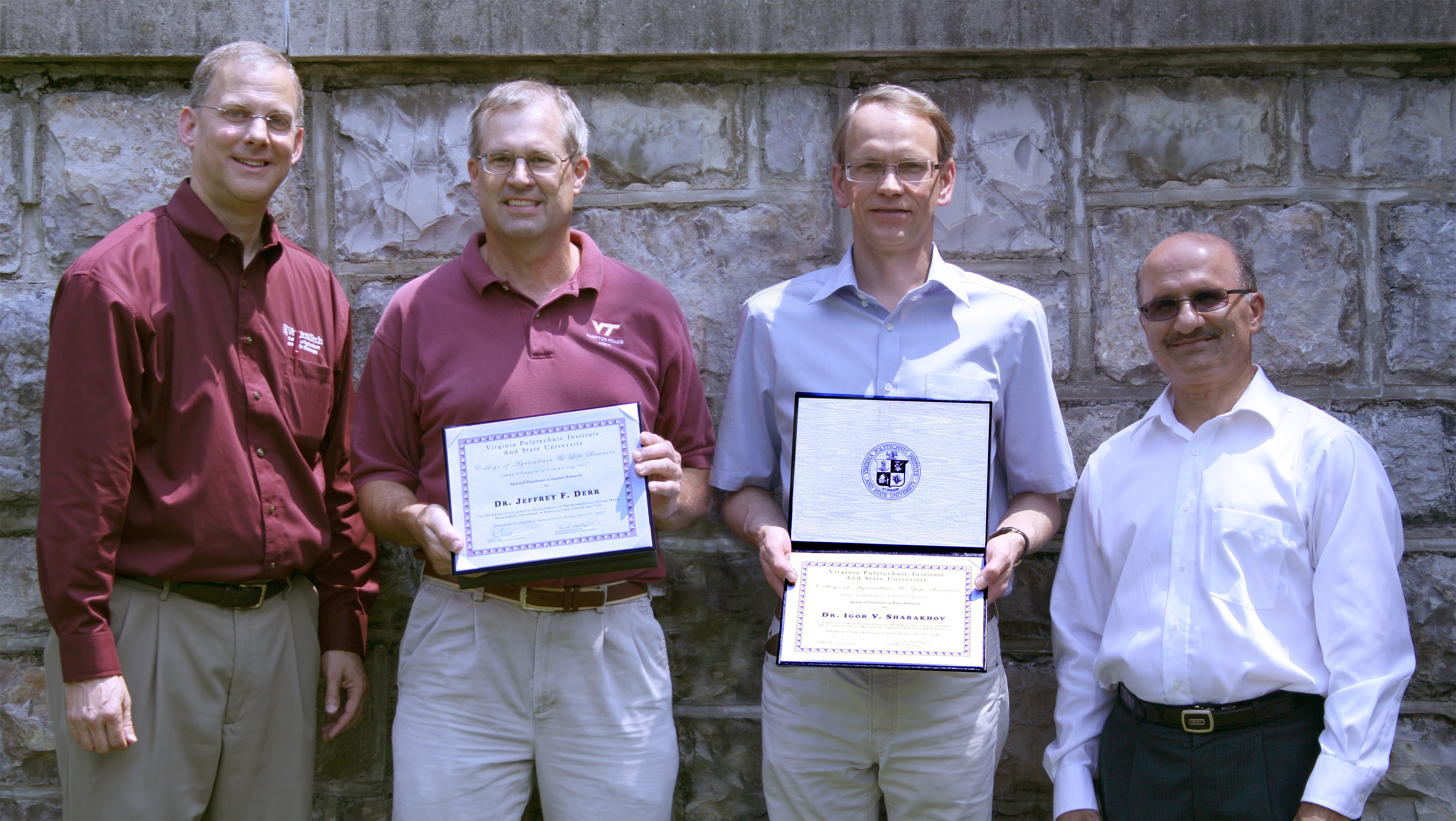 Pictured left to right: Alan Grant, Jeffrey Derr, Igor Sharakhov, and Saied Mostaghimi.  Jeffrey Derr and Igor Sharakhov hold their awards.