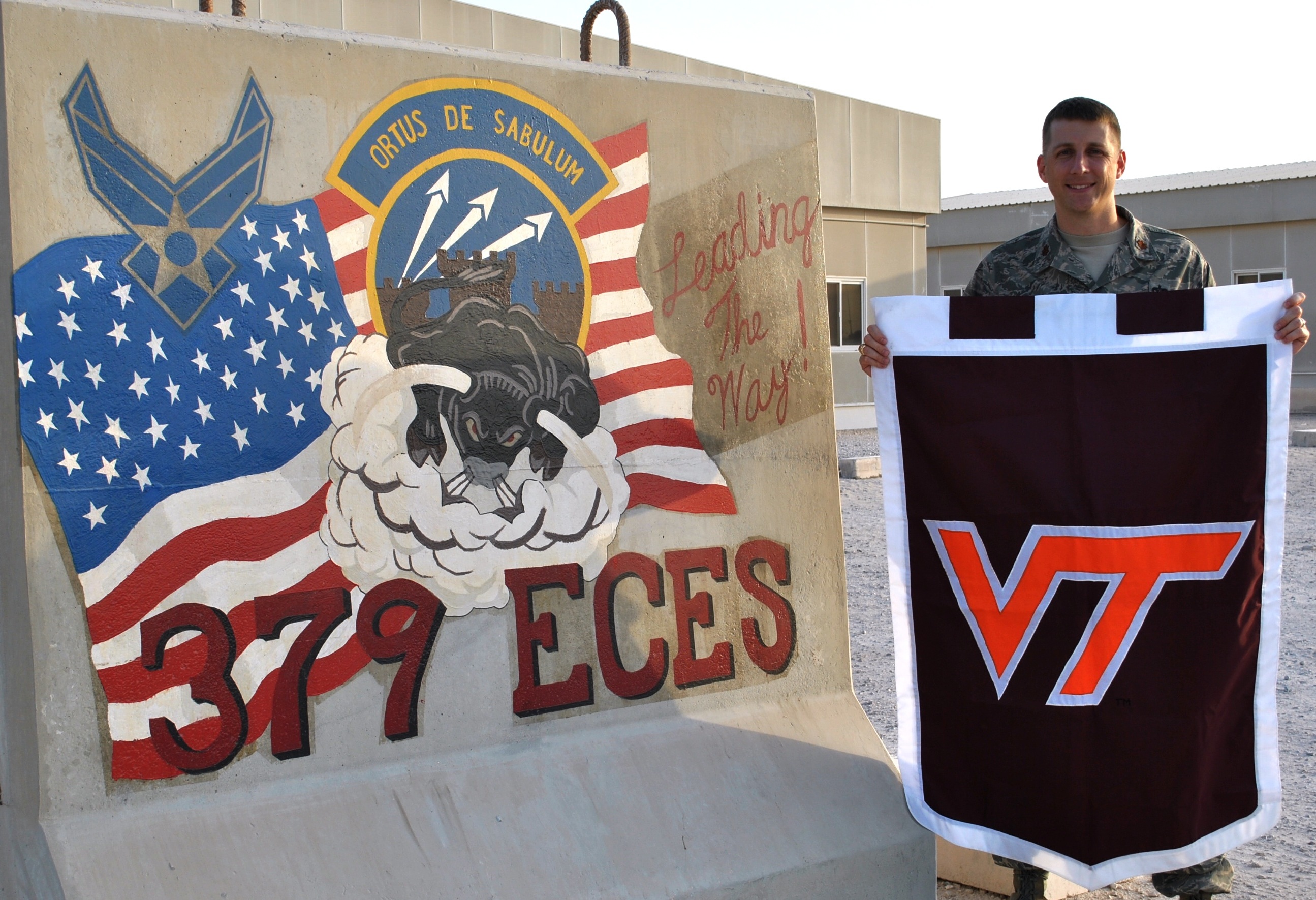 Maj. Ryan Crowley, U.S. Air Force, Virginia Tech Corps of Cadets Class of 2001 next to his unit sign.