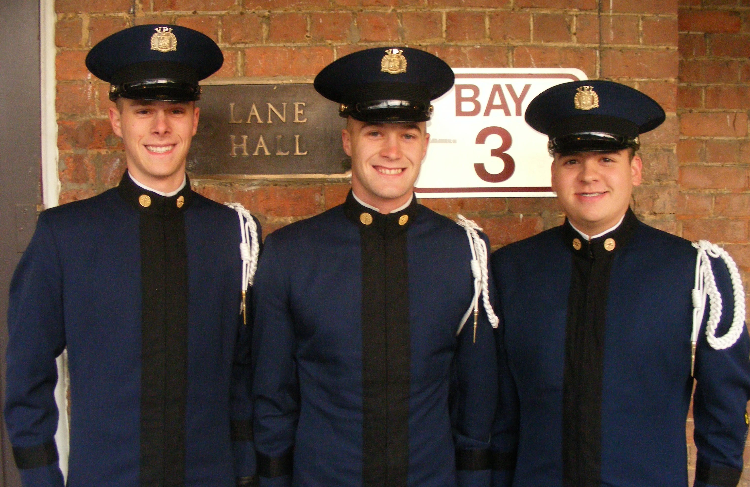 Cadets Brett Romig, William Johnson, and Trevor Penkwitz in front of Lane Hall.