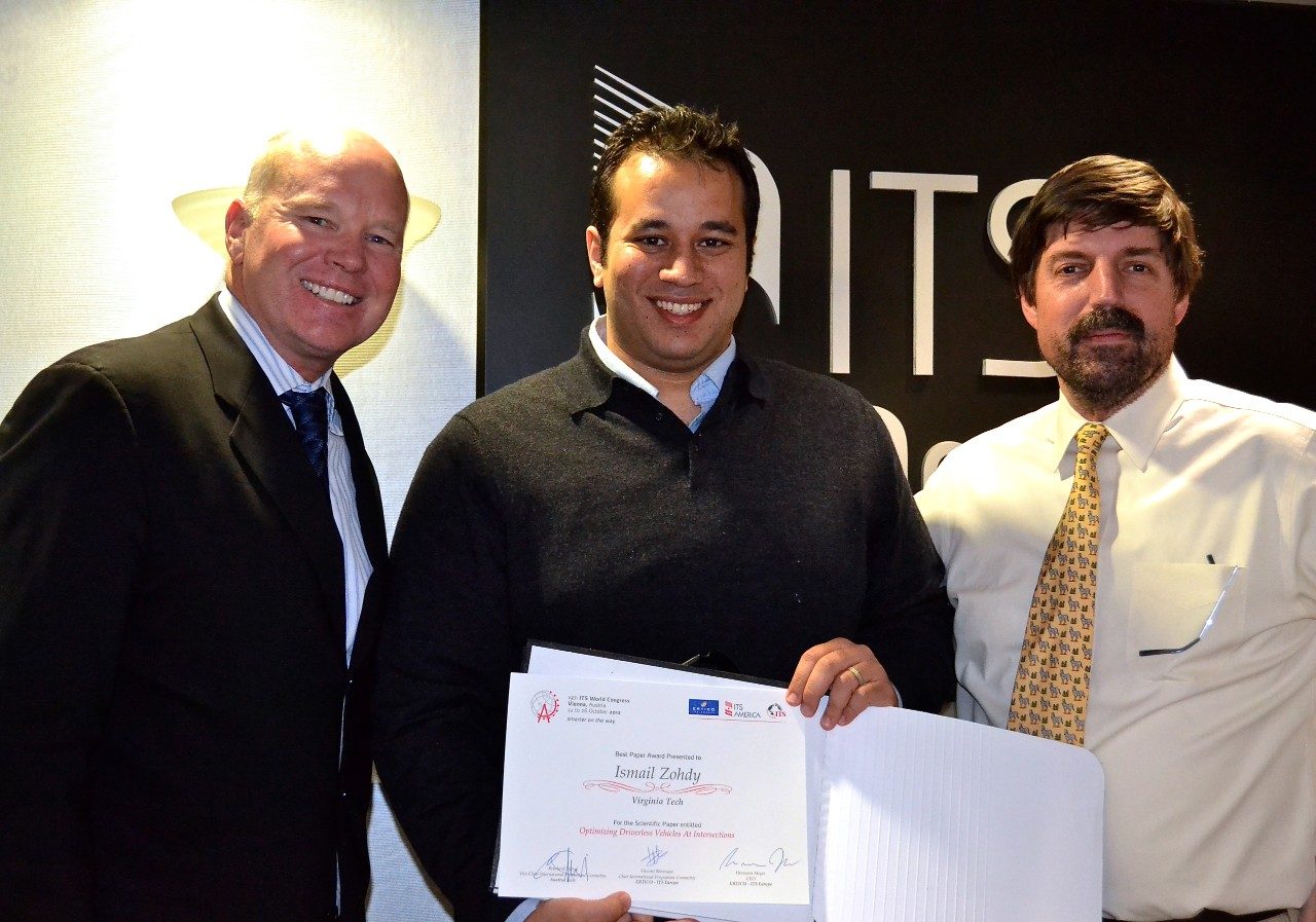Ismail Zohdy received the best paper award during a November 2012 visit to the Intelligent Transportation Society of America headquarters in Washington, D.C. Pictured here are Scott F. Belcher, ITSA president and CEO; Zohdy; and Tom Kern, ITSA executive vice president.