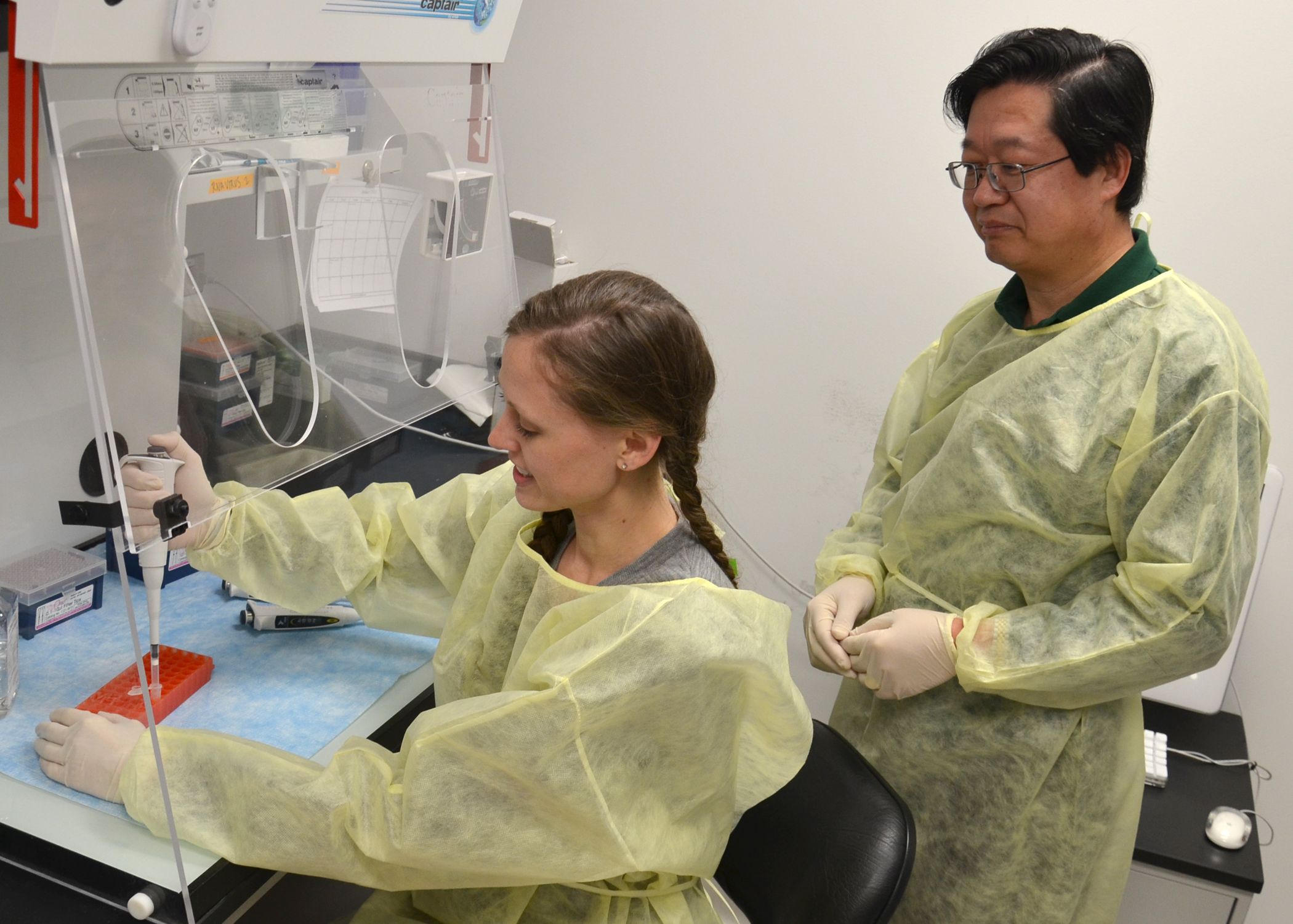 Dr. X.J. Meng and Dr. Danielle Yugo in the lab