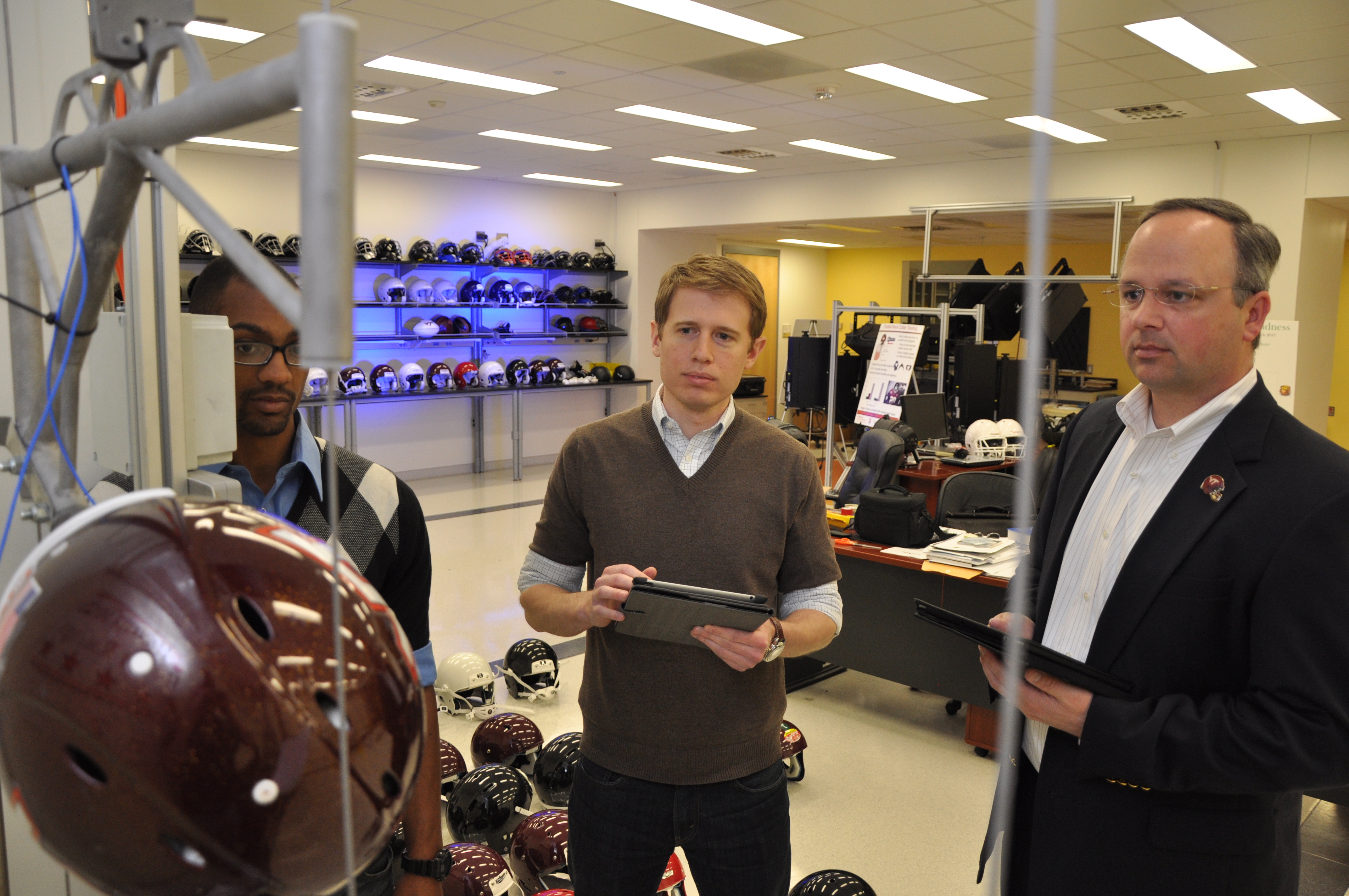 Testing the various football helmets for their ability to reduce the risk of concussions, from left to right, are: Steven Rowson, an assistant professor, and Stefan Duma, the Harry C. Wyatt Professor and department head, both of the Virginia Tech-Wake Forest School of Biomedical Engineering and Science.