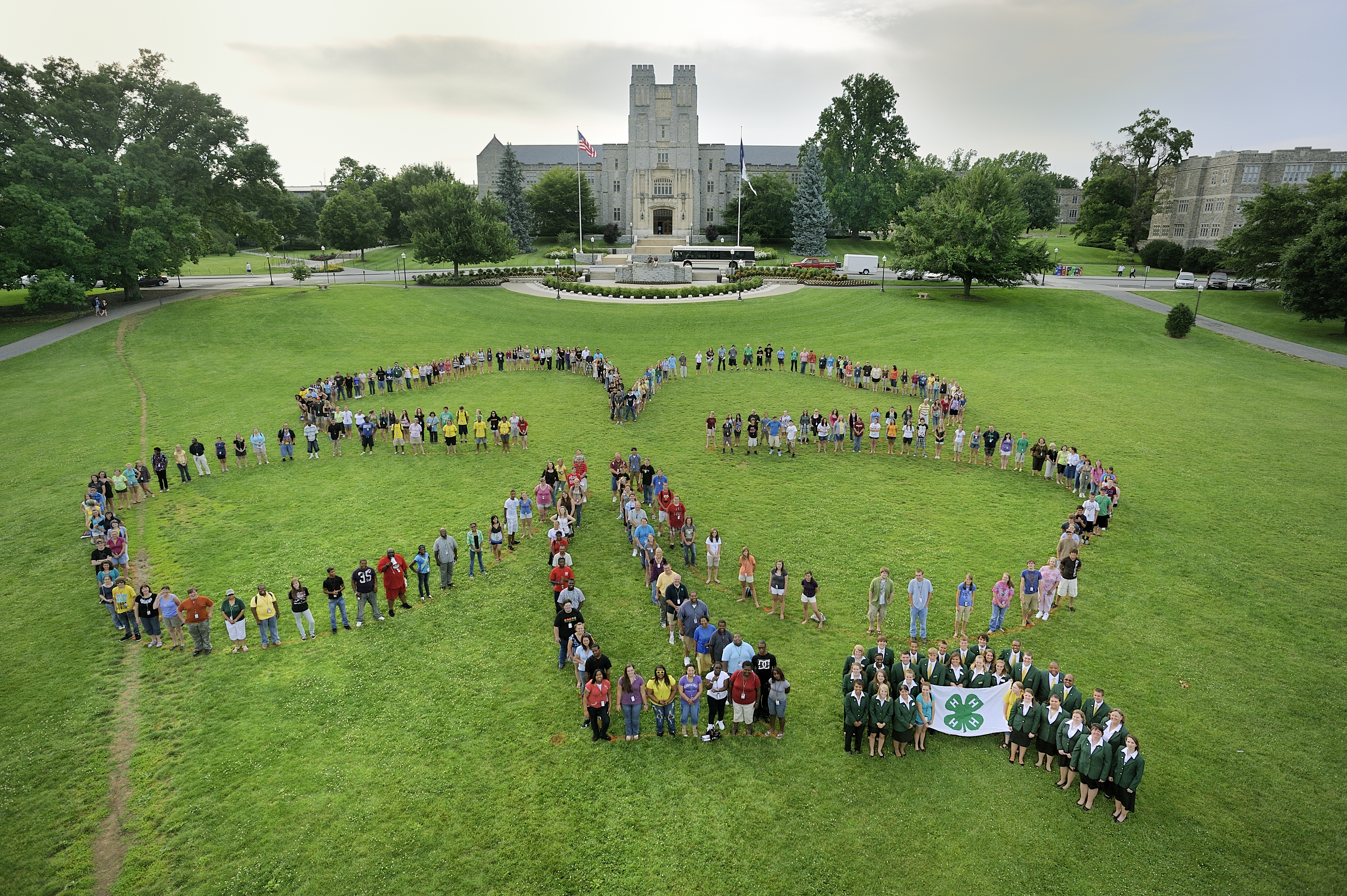4-H members stand in the organization's signature formation on Virginia Tech's verdant Drillfield.